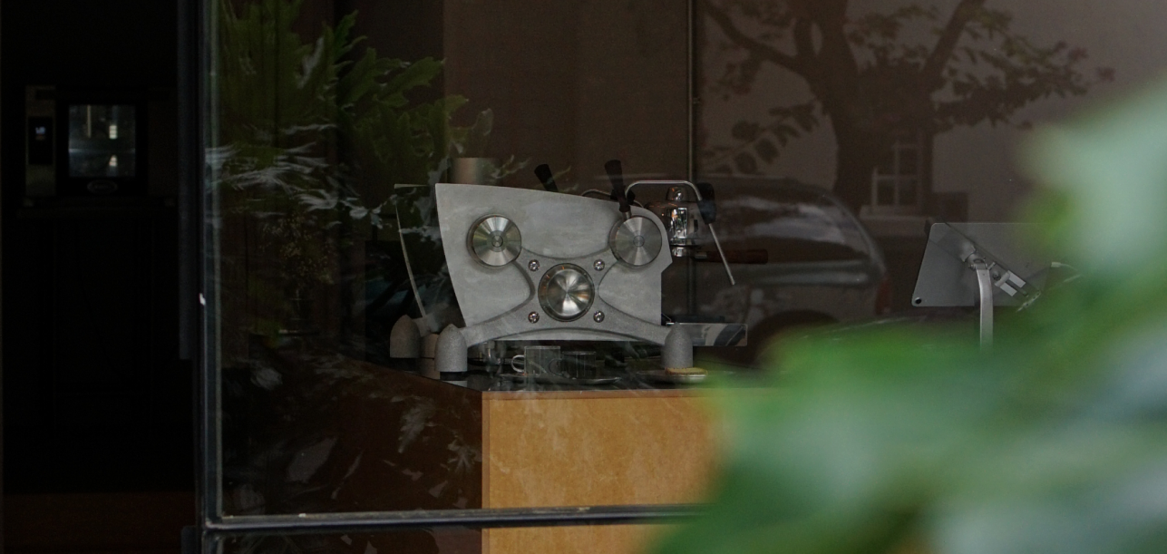 Espresso machine on the bar at post, seen from the street